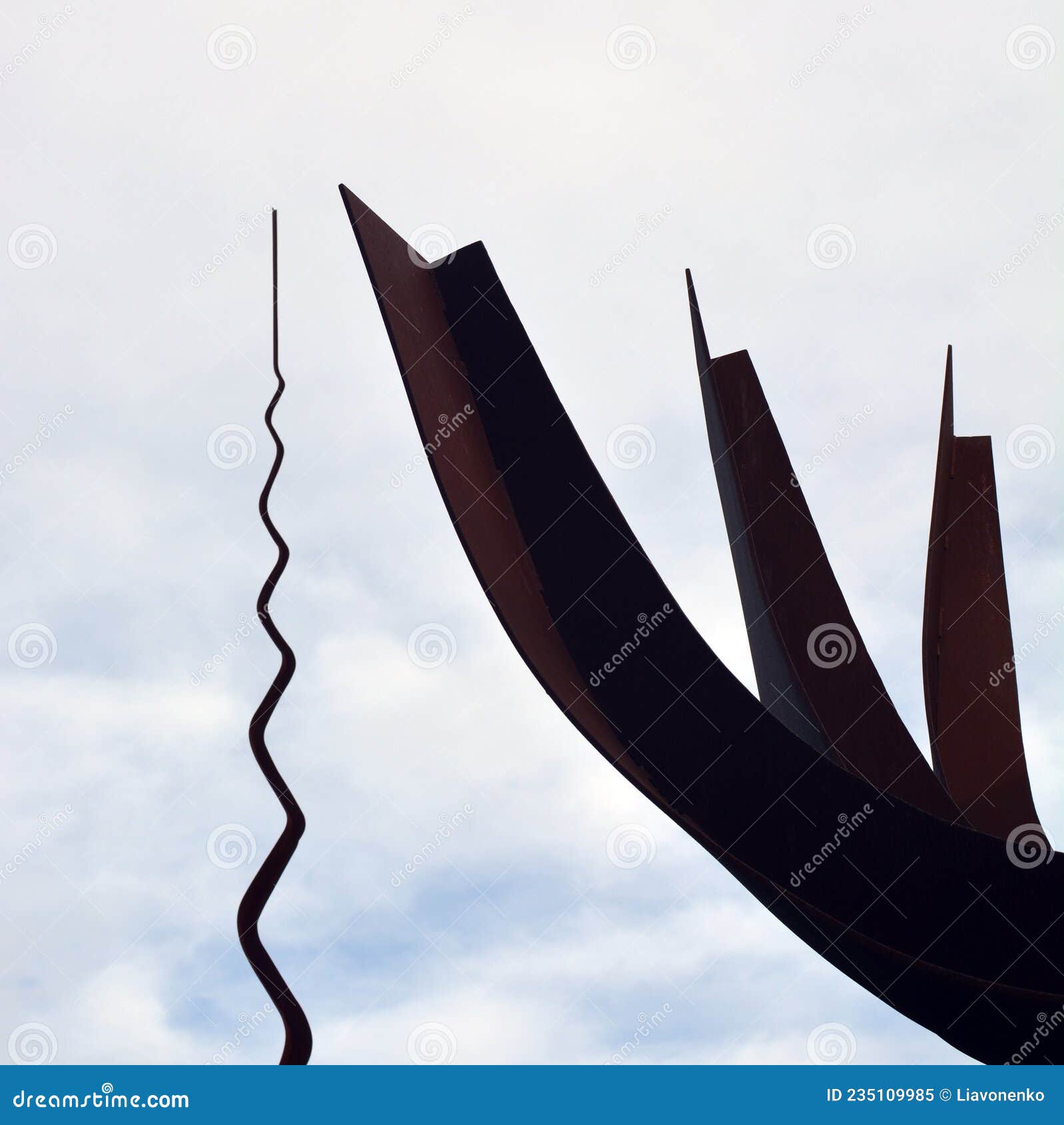 metal monument. on the sky background. peace park almada portugal. monumento de ferro. parque de paz. cÃÂ©u nublado.