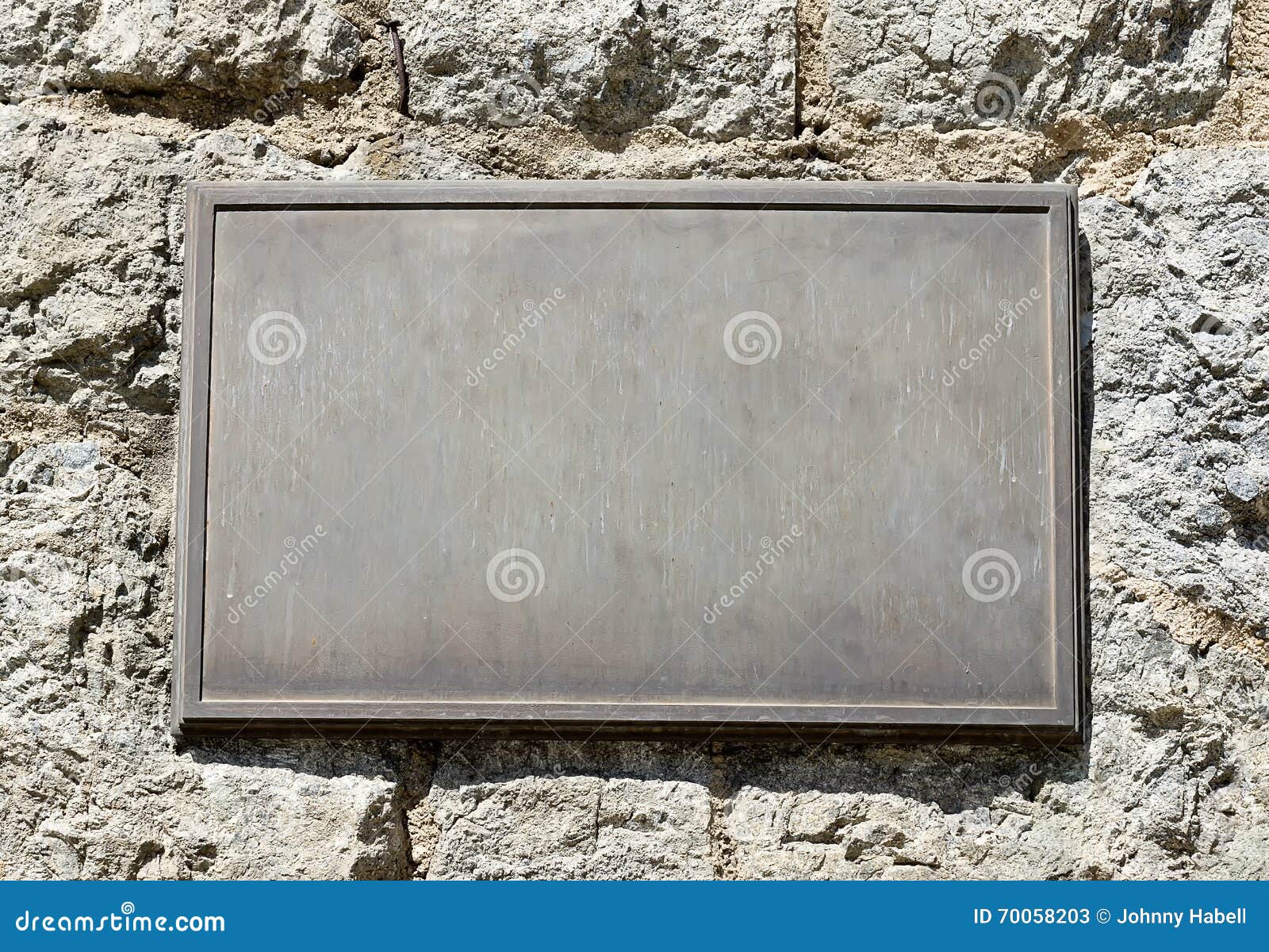 metal plaque on stone wall