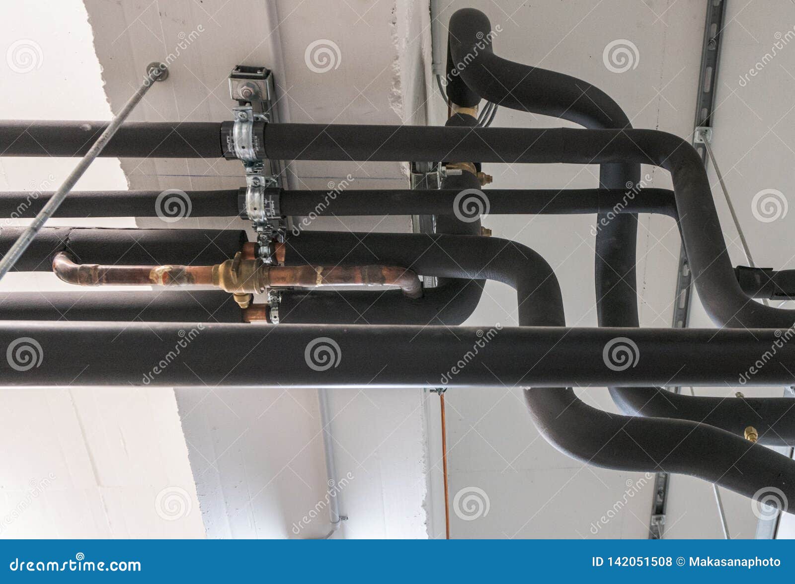 Metal and Plastic Pipe System on the Cellar Ceiling of an Apartment