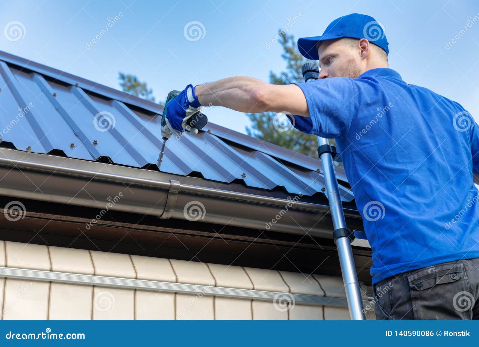 metal roofing - roofer working on the house roof