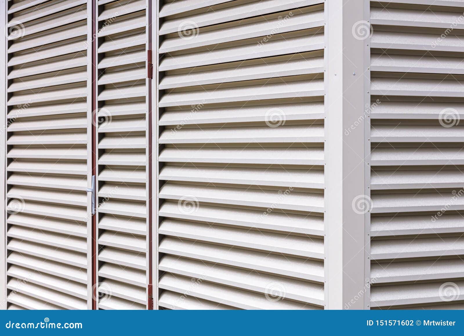 Metal Sheet Louver or Slats on the Wall of Warehouse Stock Photo