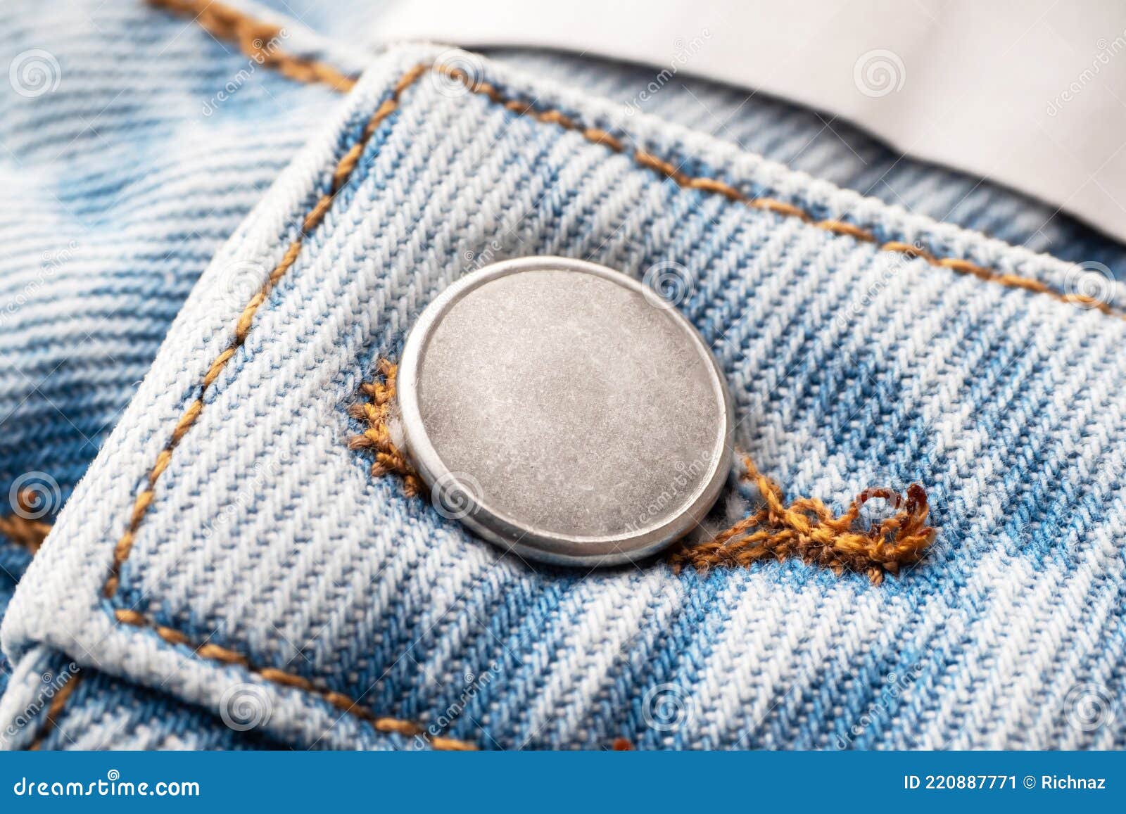 Metal Silver Button on Jeans, Closeup. Elements of Denim Clothing