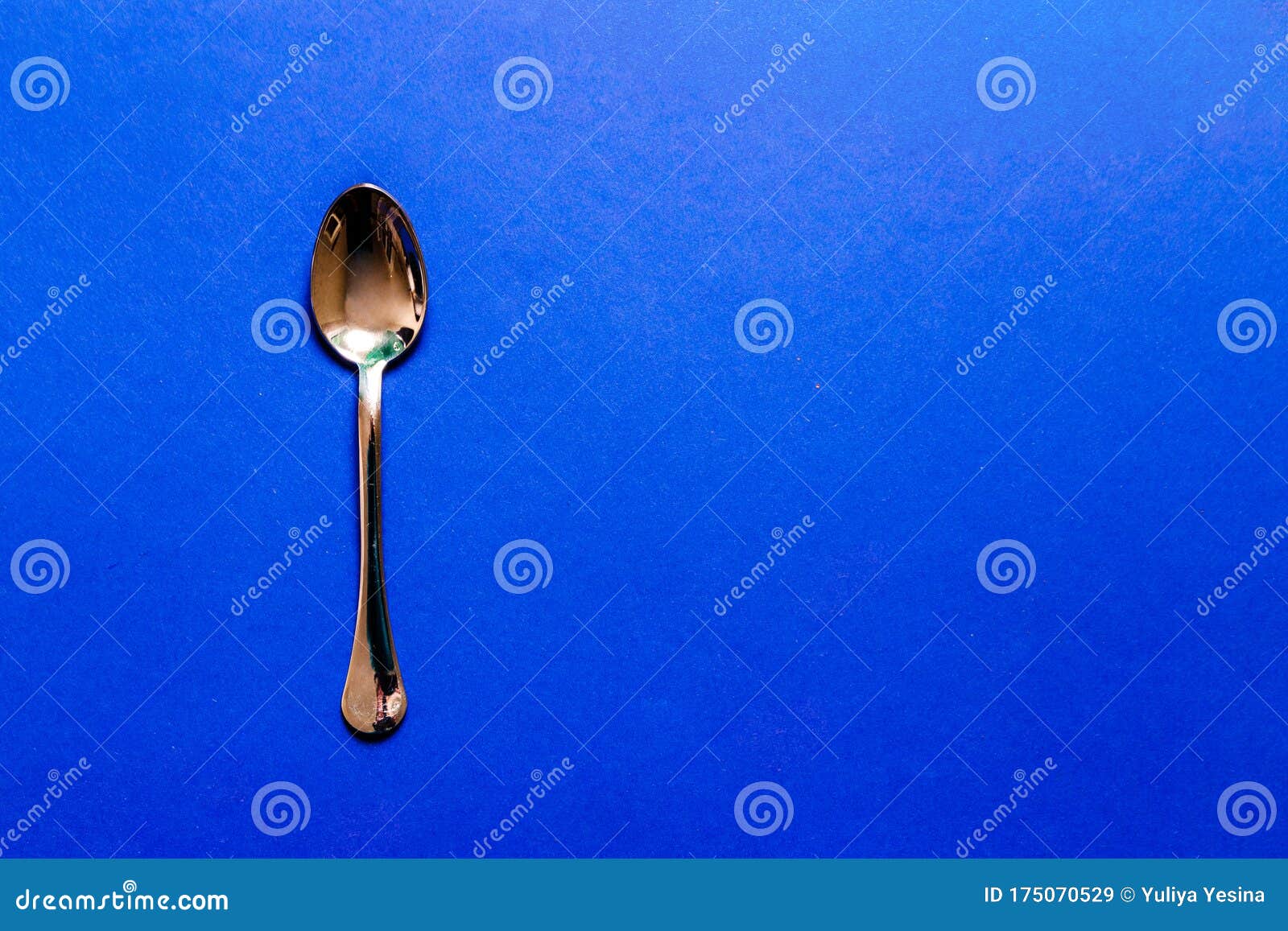A Metal Spoon on a Dark Blue Surface Stock Image Image of background