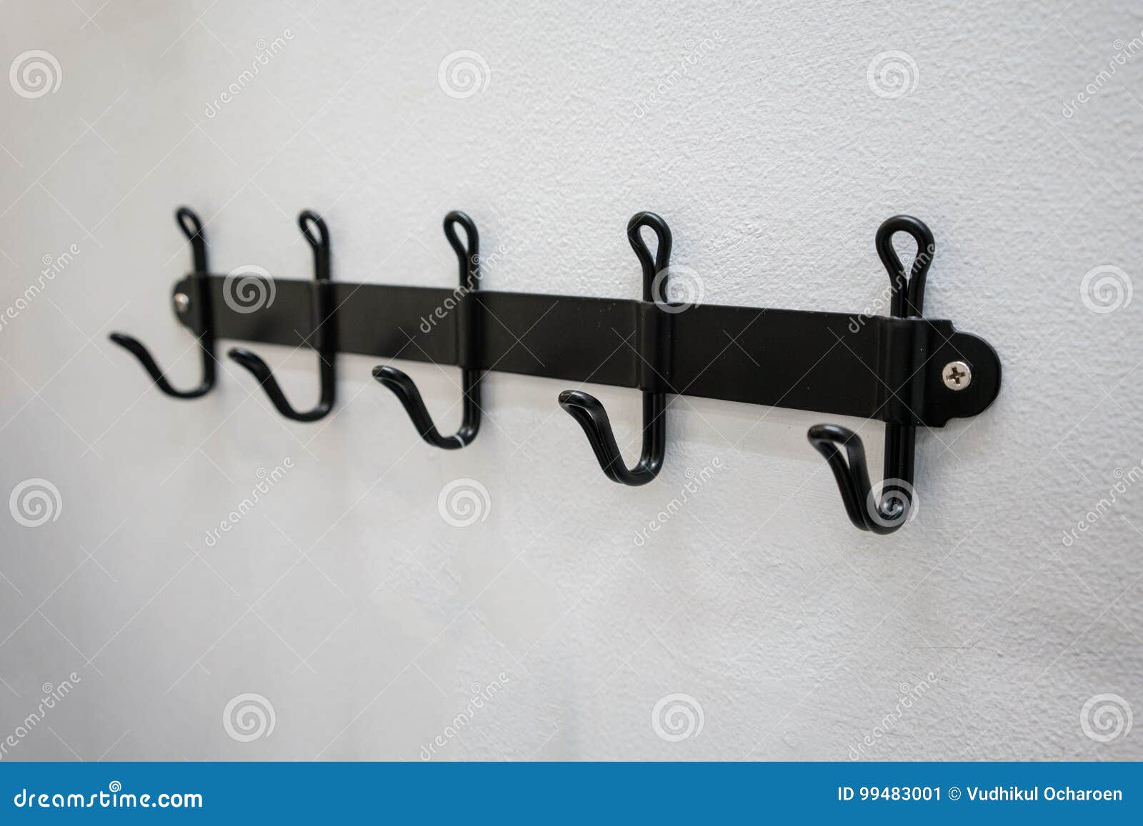 Metal Wall Hanger Mounted Against White Wall. Stock Image Image of