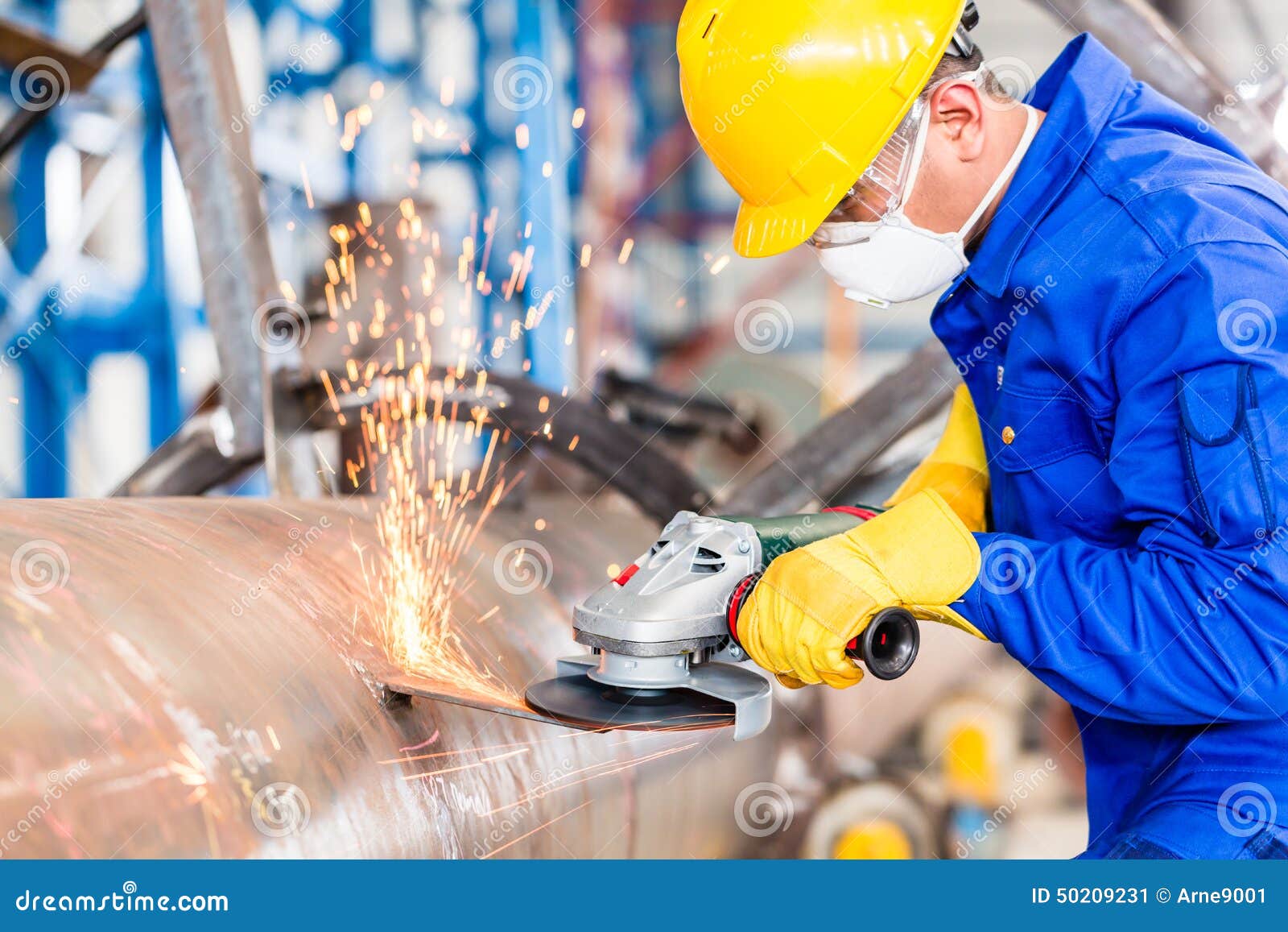 metal worker in factory grinding metal of pipeline