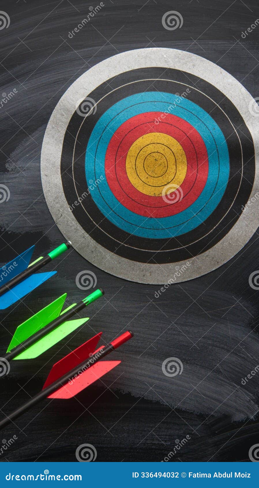 metallic archery target emblem on chalkboard, arrows in various colors
