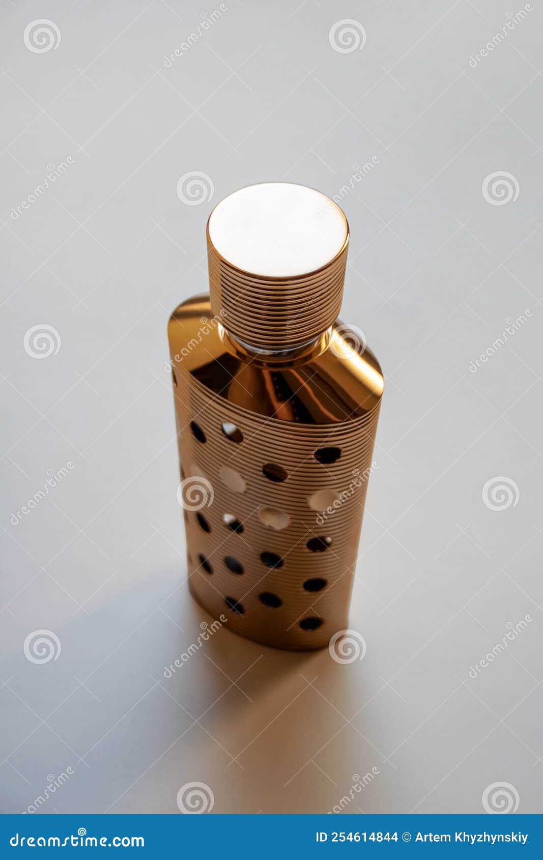 Metallic Gold Perfume Bottle Container in Art Deco Style Stock Photo