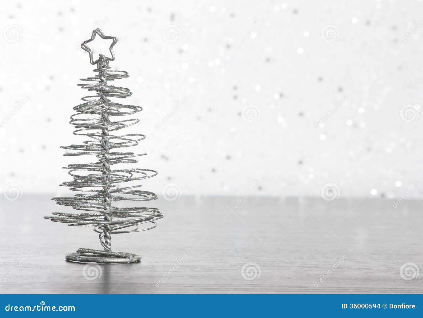 metallic modern christmas tree on wood table