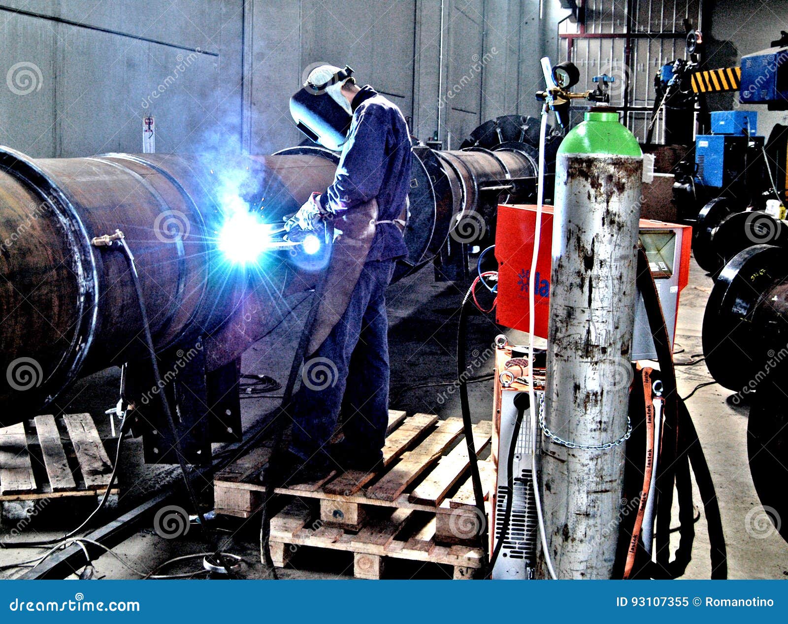 Metalwork Construction of Large Tubes with Workers Working Welding