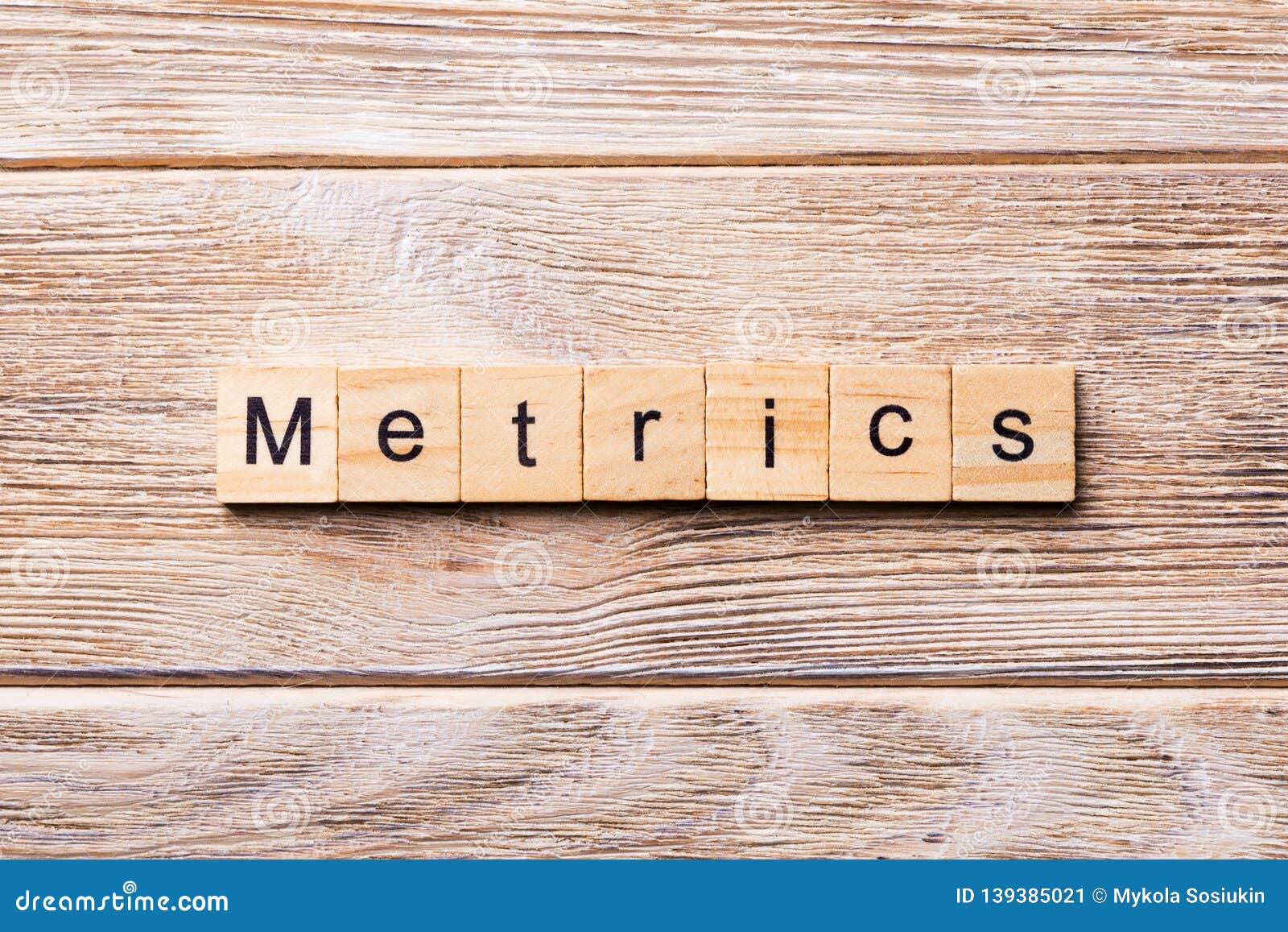 metrics word written on wood block. metrics text on wooden table for your desing, concept