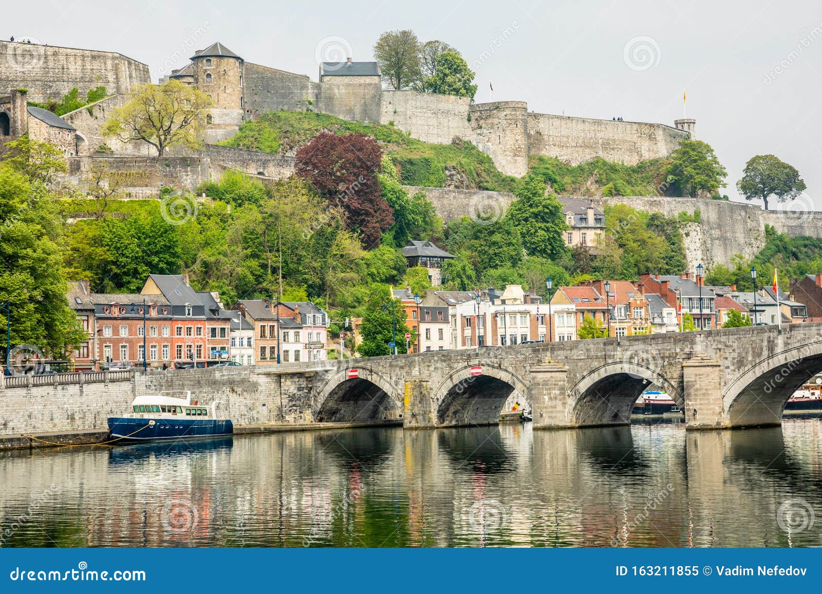 meuse river with jambes bridge and citadel of namur fortress on the hill, namur, wallonia, belgium