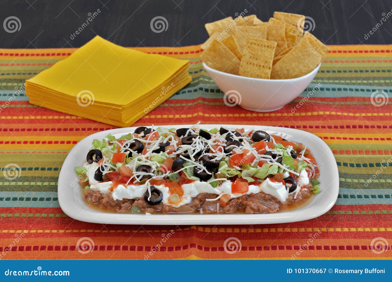 Mexican Bean Layered Dip stock image. Image of napkins 101370667