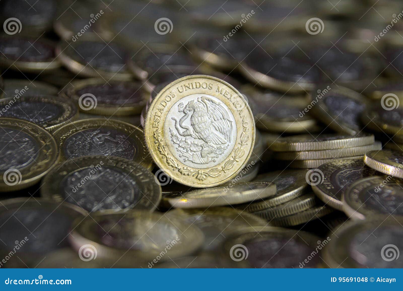 mexican currency in the foreground, between more coins