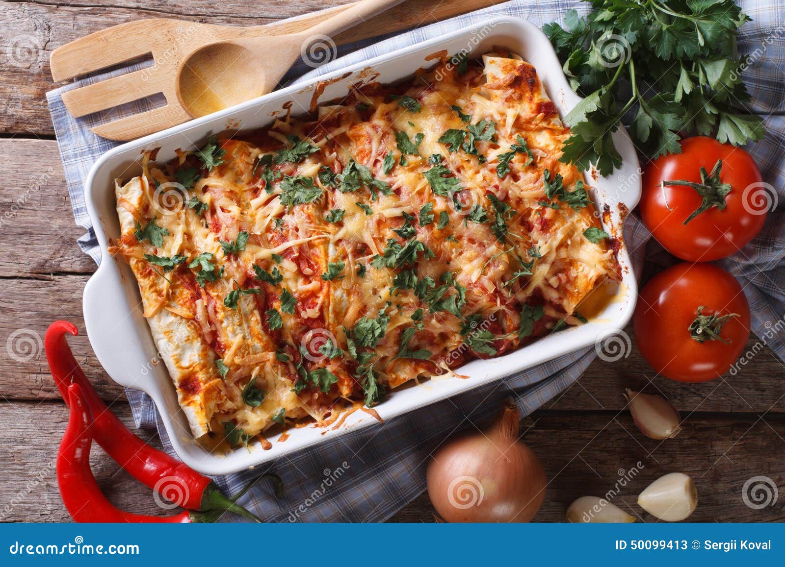 mexican enchilada in a baking dish horizontal top view close-up