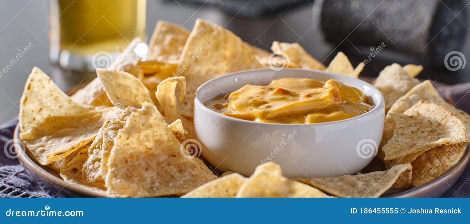 mexican hot queso cheese dip with corn tortilla chips on plate