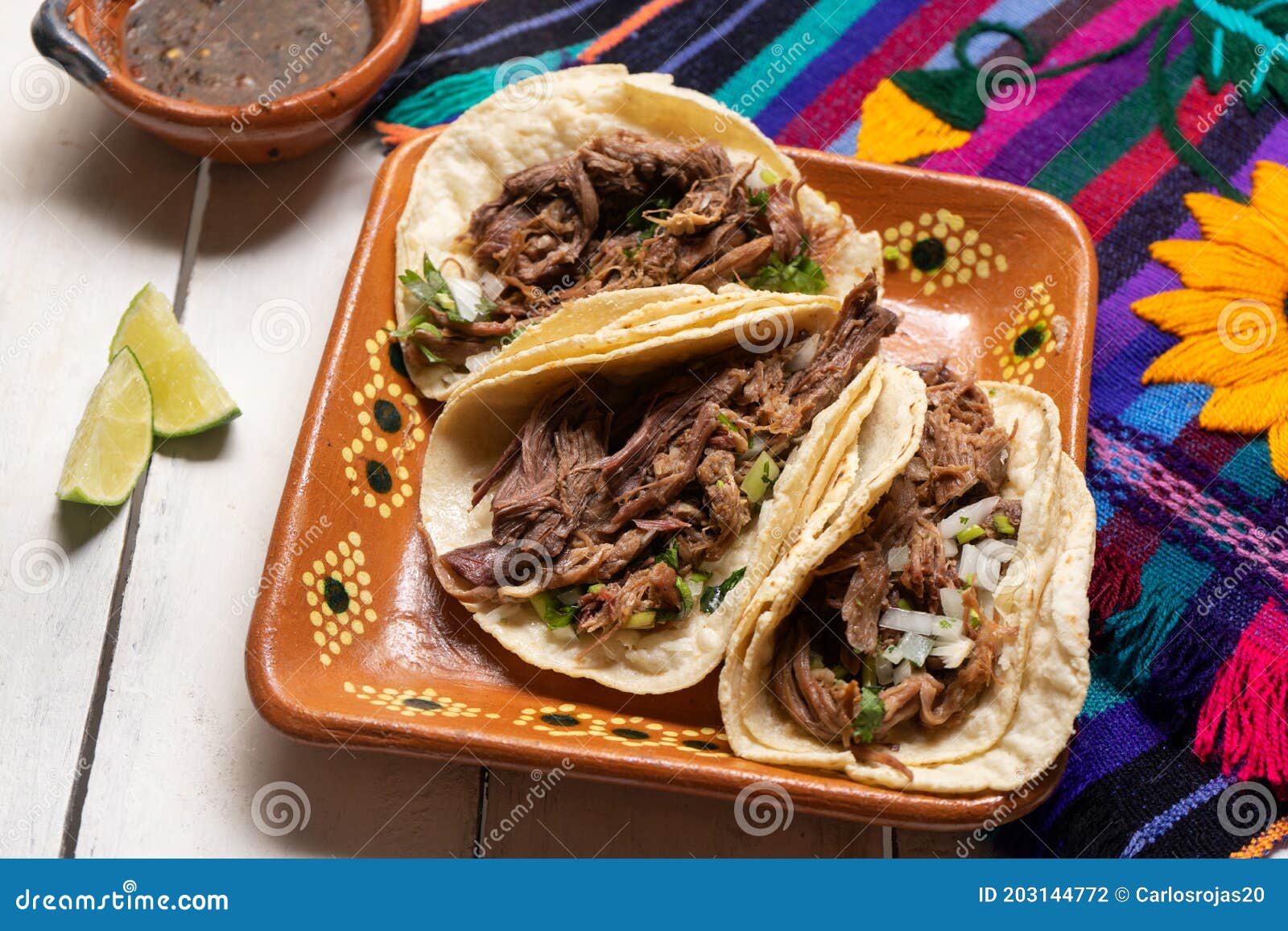 mexican slow cooked lamb tacos also called barbacoa on white background
