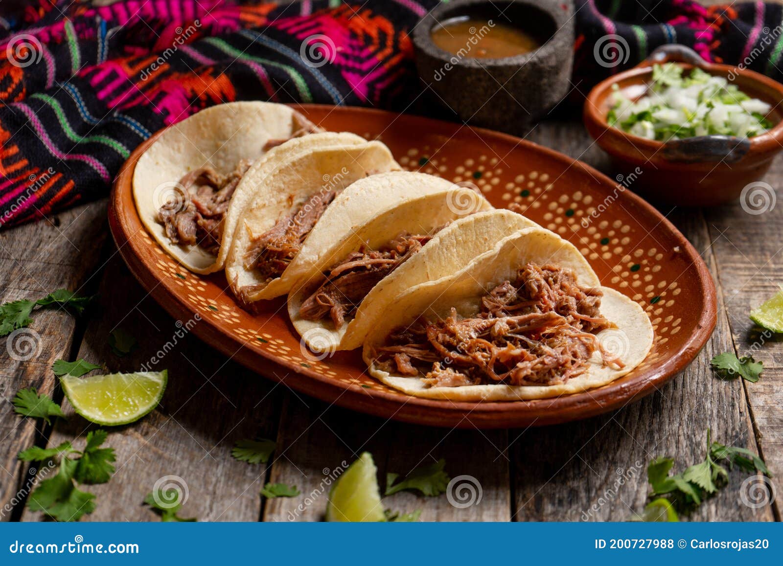 mexican slow cooked lamb tacos also called barbacoa on wooden background
