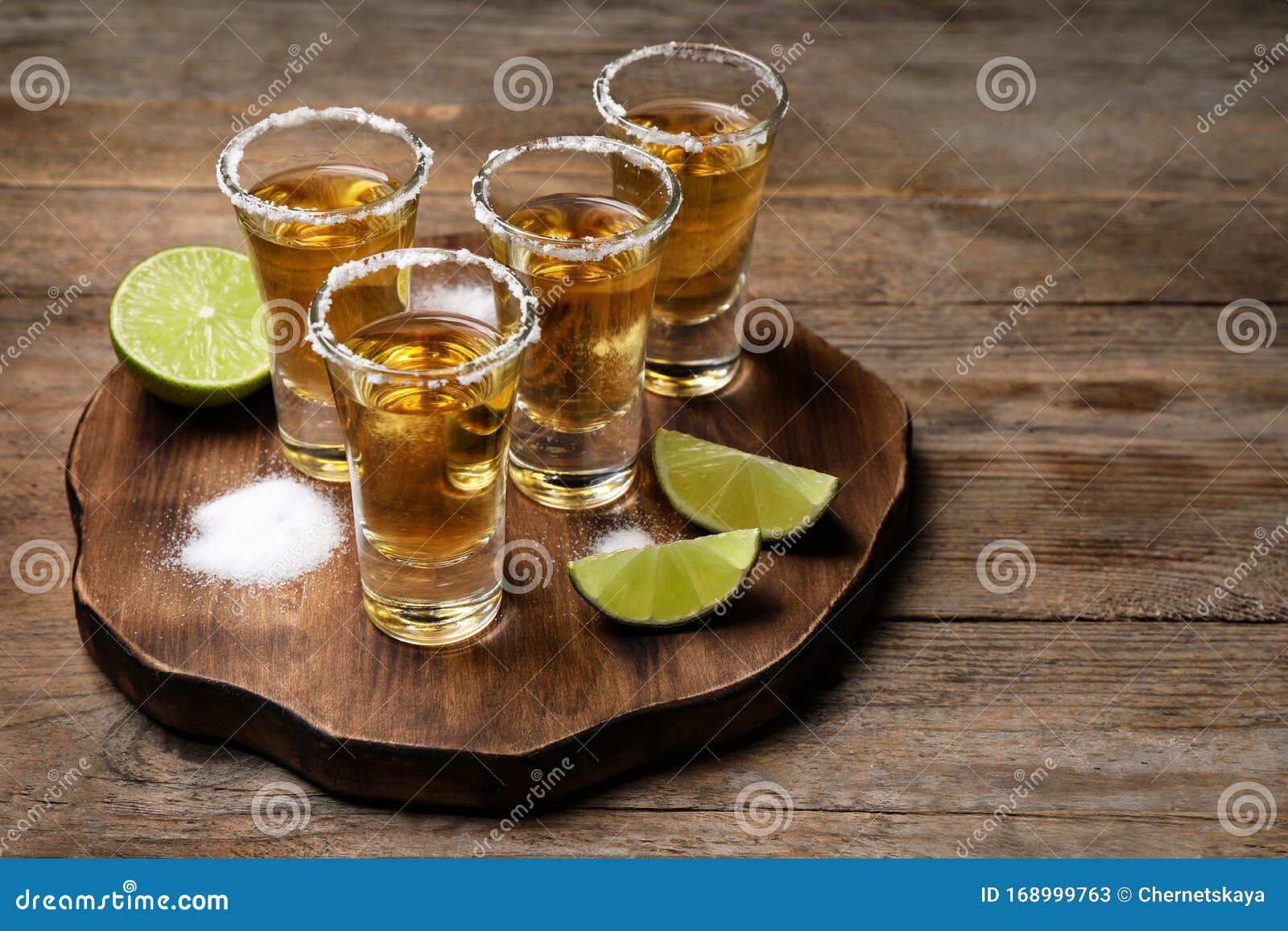 mexican tequila shots, lime and salt on table