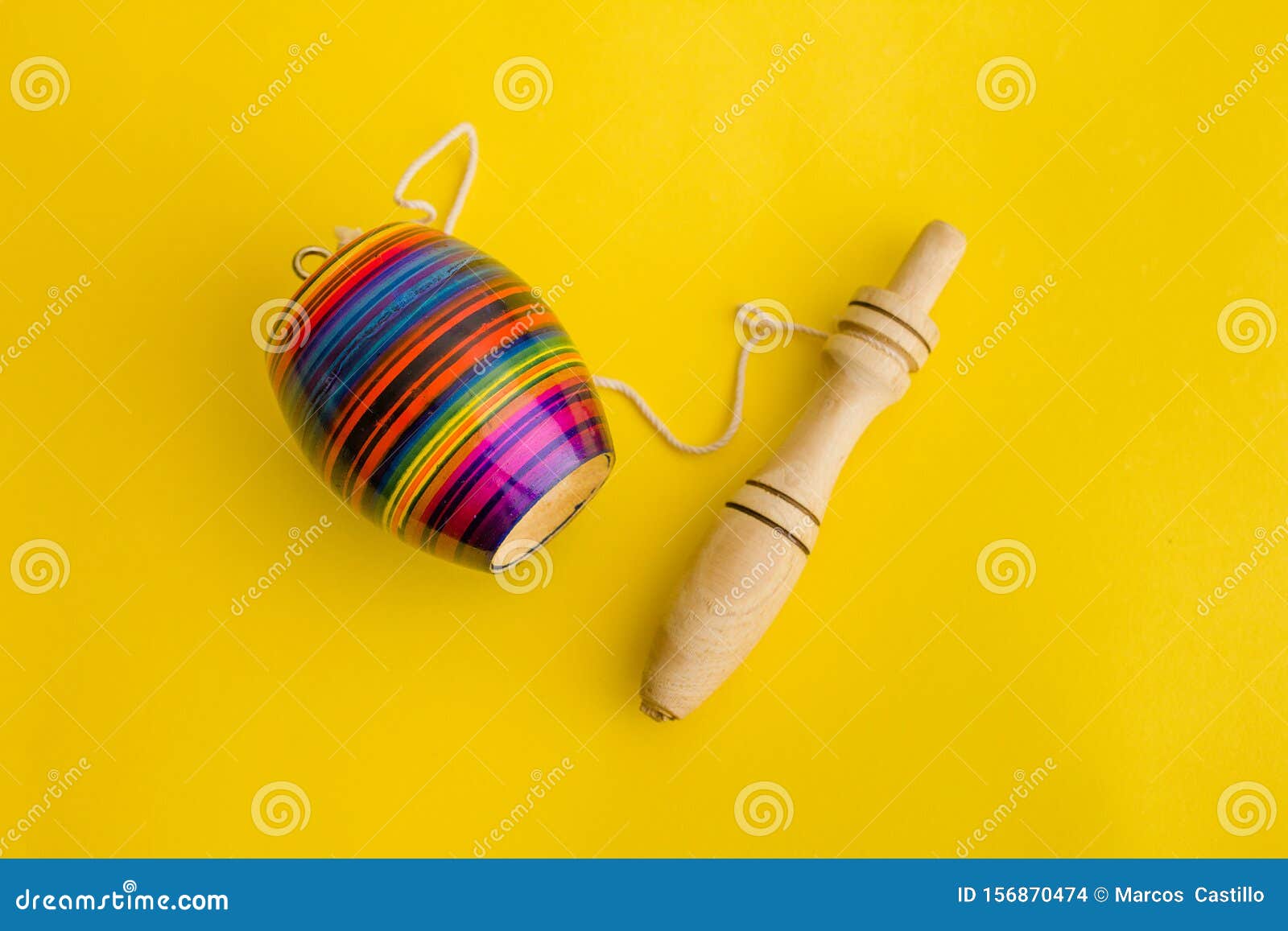 mexican toys, balero from wooden in mexico on yellow background
