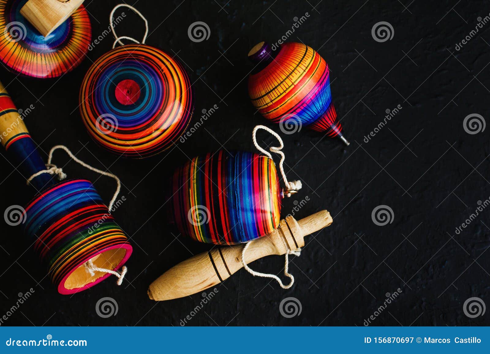 mexican toys from wooden, balero, yoyo and trompo in mexico on black background