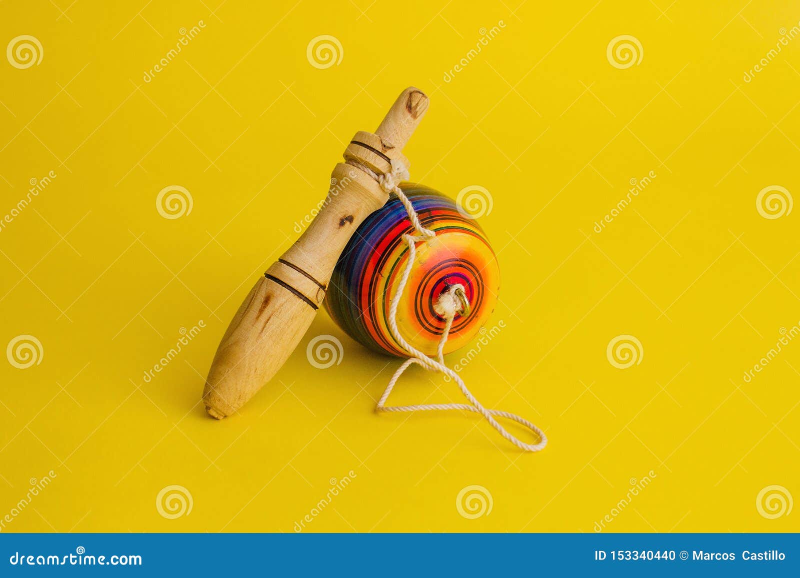 mexican toys from wooden, balero, yoyo and trompo in mexico on a yellow background
