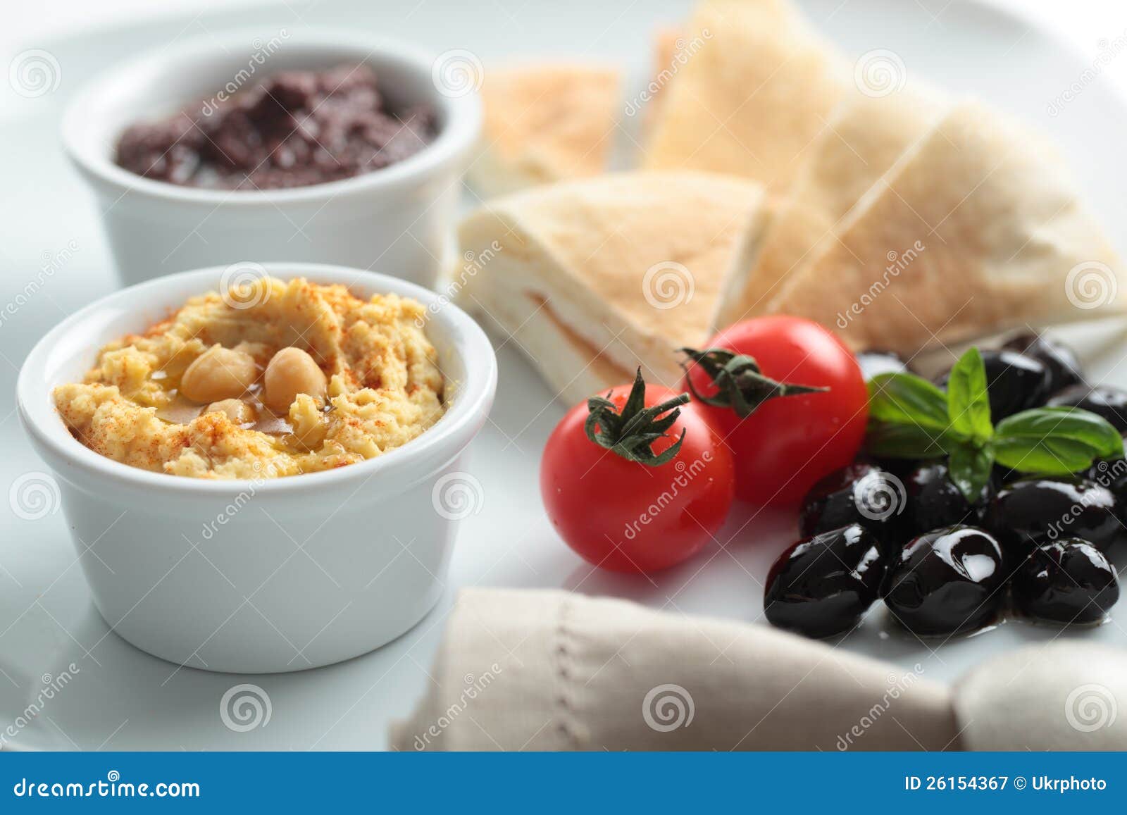 meze with tomato, olives, and pita bread