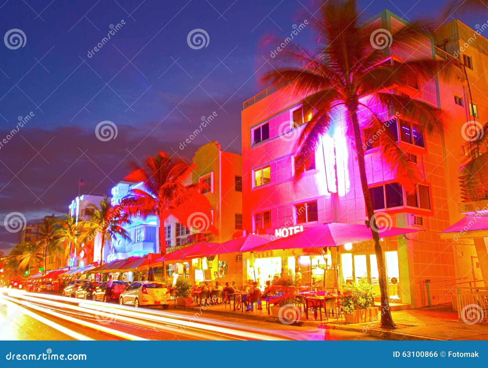 miami beach, florida moving traffic hotels and restaurants at sunset on ocean drive