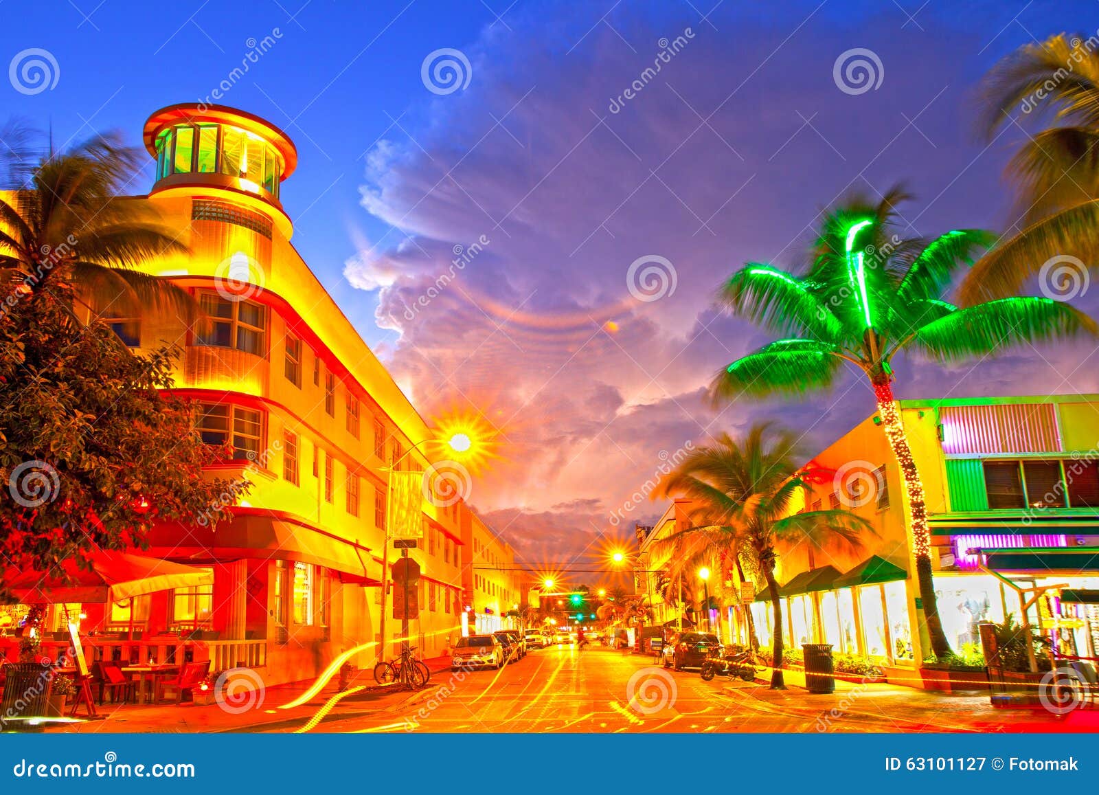 miami beach, florida moving traffic hotels and restaurants at sunset on ocean drive