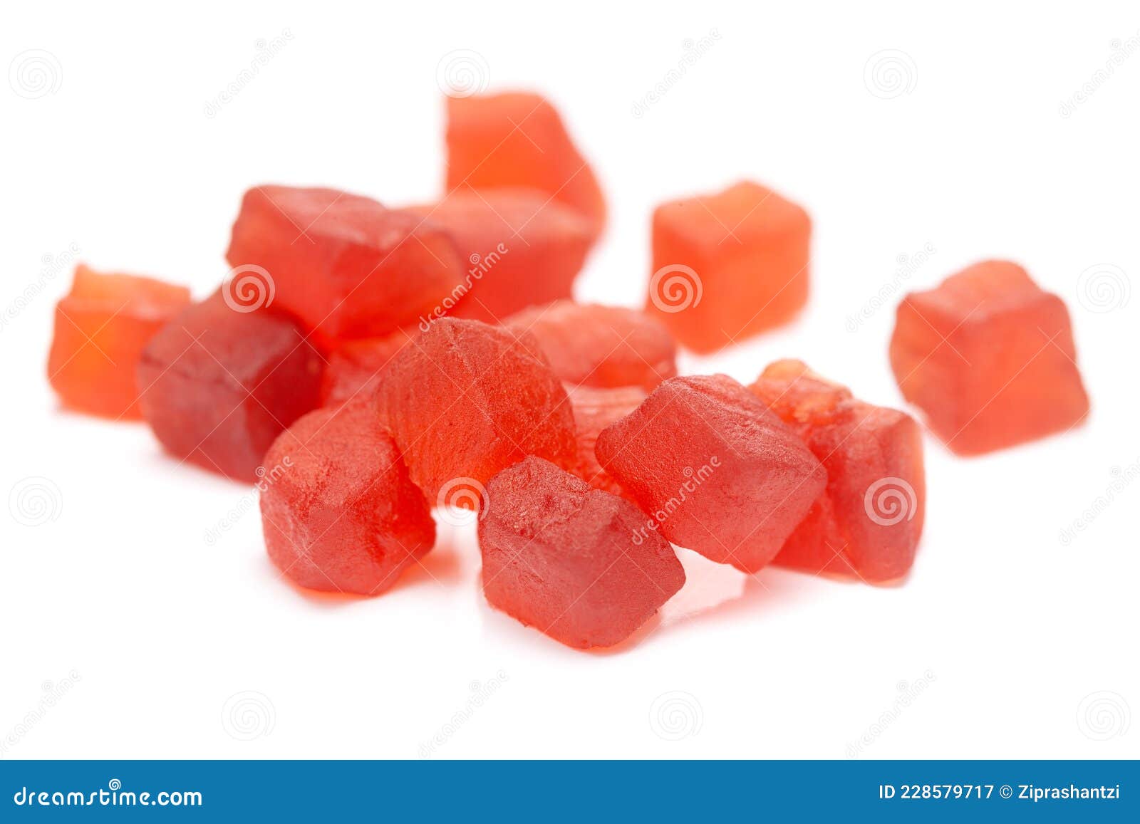 micro close-up and details of organic indian red tutti frutti sweet soft candy   over white background