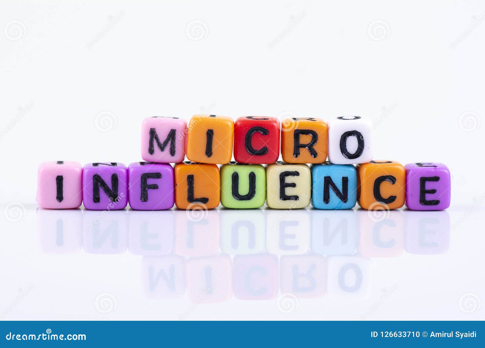 micro influence word block concept on white reflection table