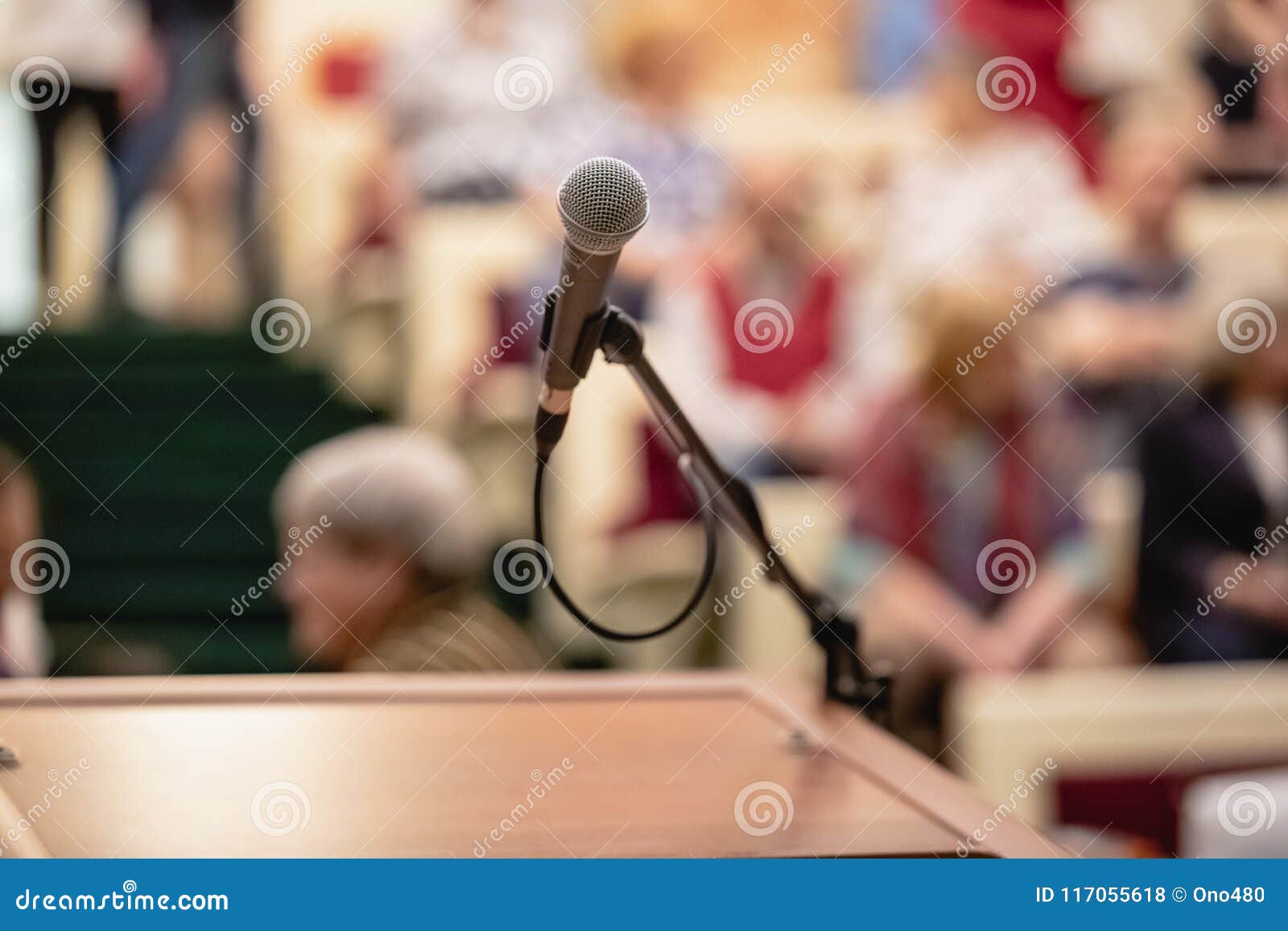 microphone on abstract blurred of speech in seminar room or speaking conference hall light, event background