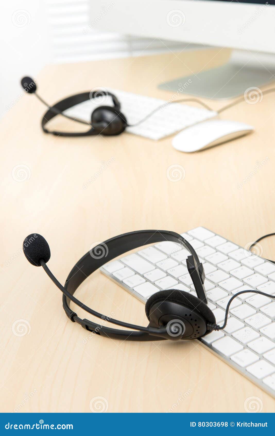 Microphone Headsets on the Table with Computer Keyboards in Call Stock