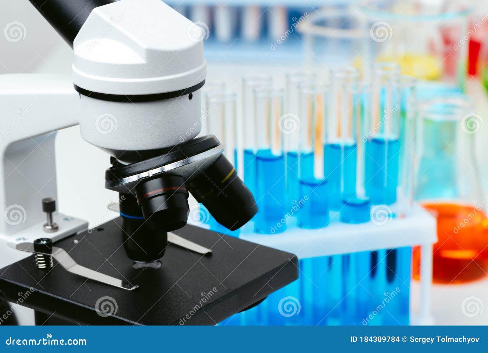 Microscope and Test Tubes on Table in Laboratory, Close Up Stock Photo ...