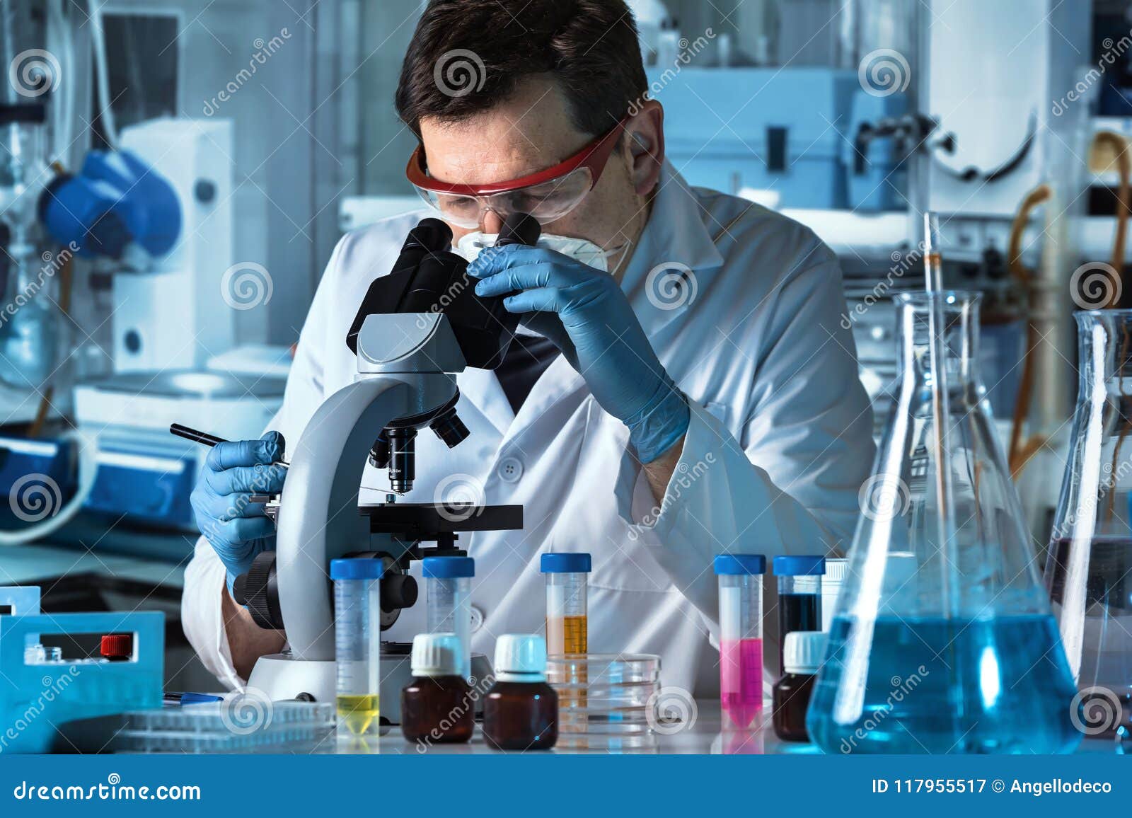 microscopist analyzing samples in the microscope