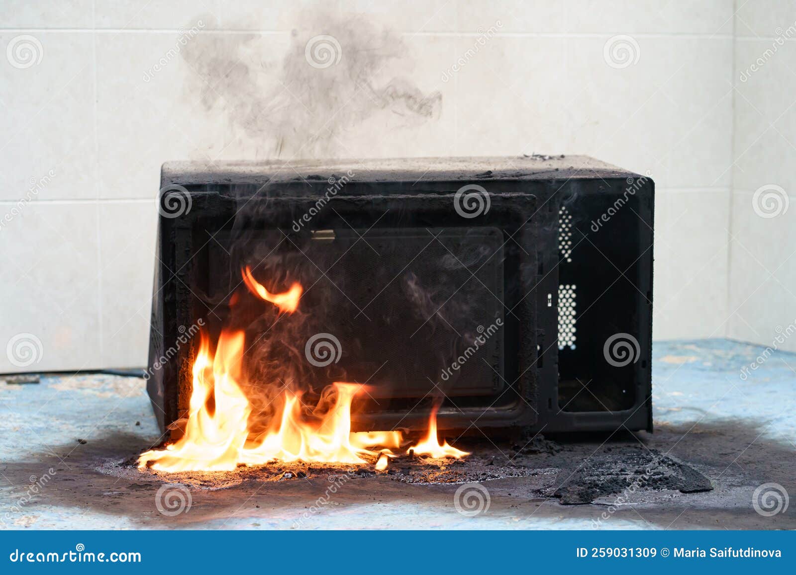 Microwave Oven on Fire. the Concept of Fire in the Kitchen. Stock Image