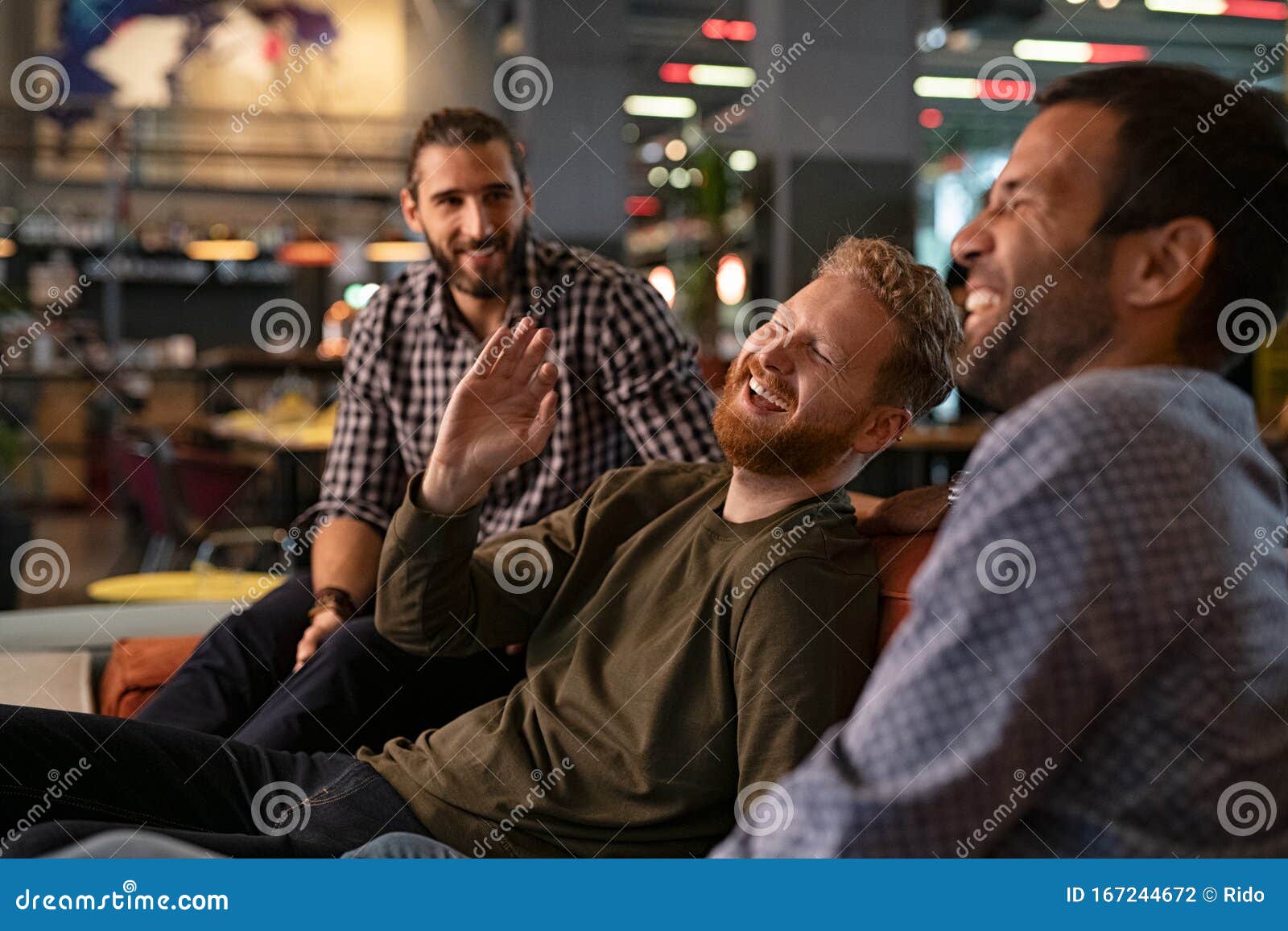 mid adult men friends enjoying at pub