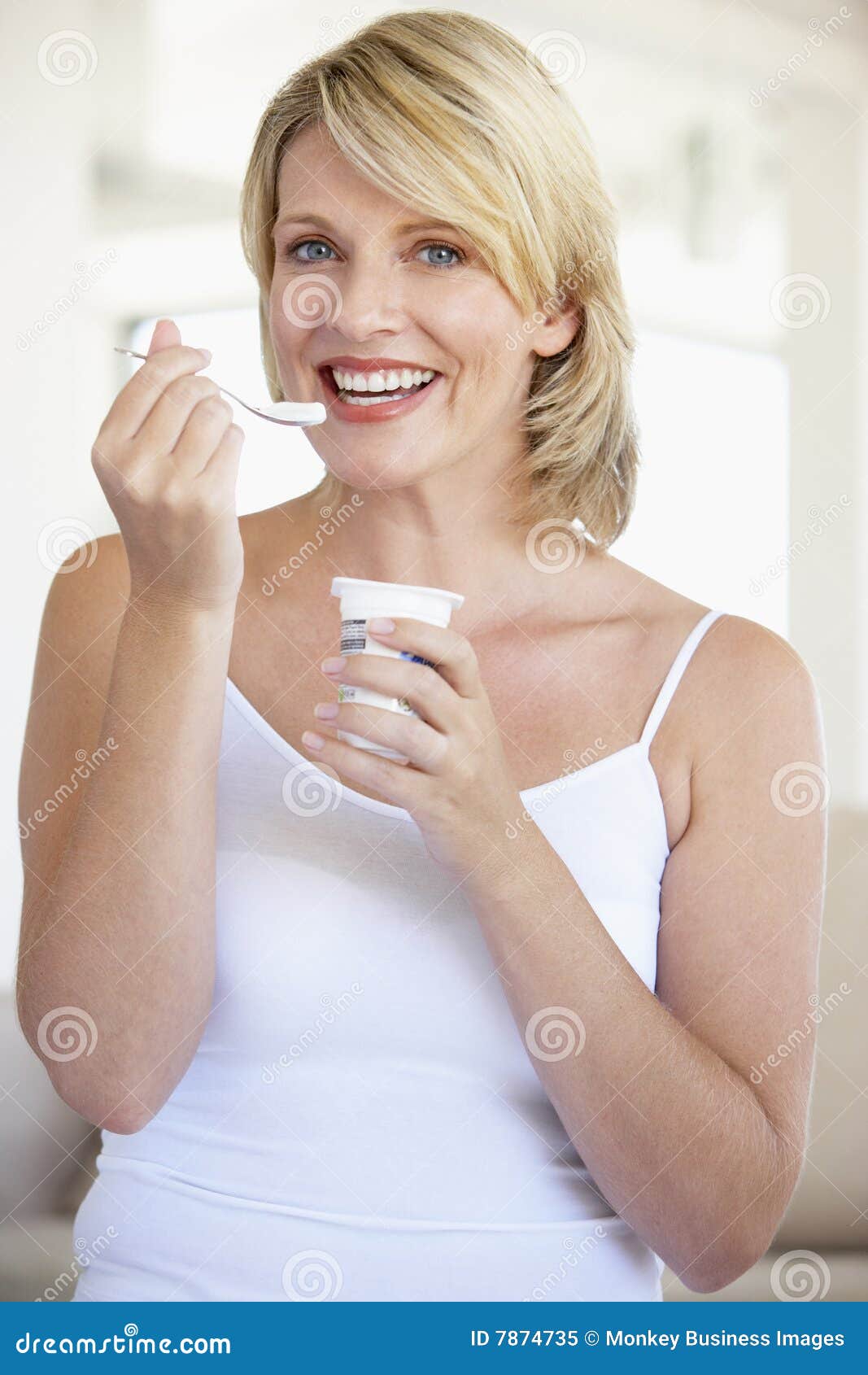 Mid Adult Woman Eating Yogurt.