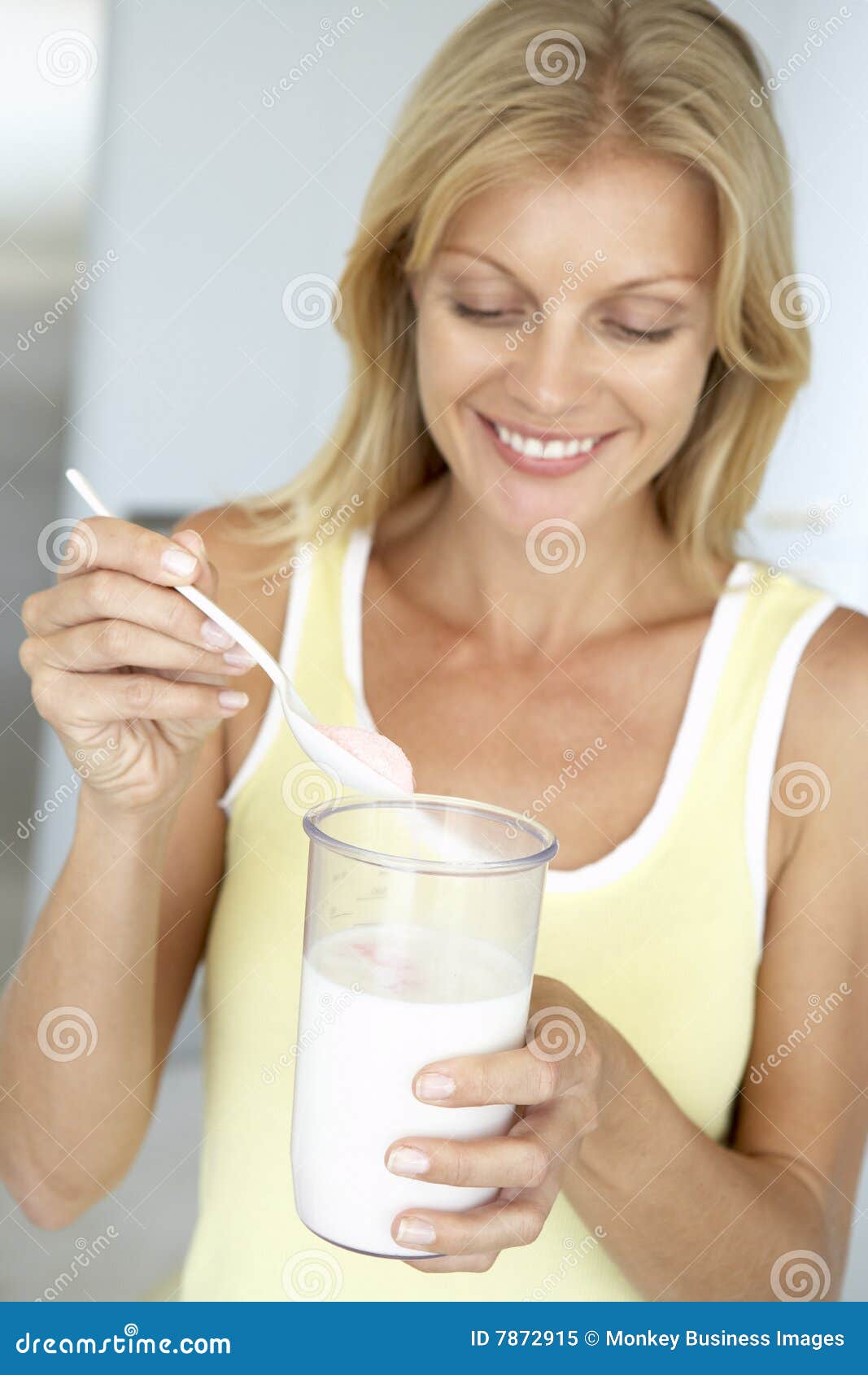 mid adult woman holding dietary supplements