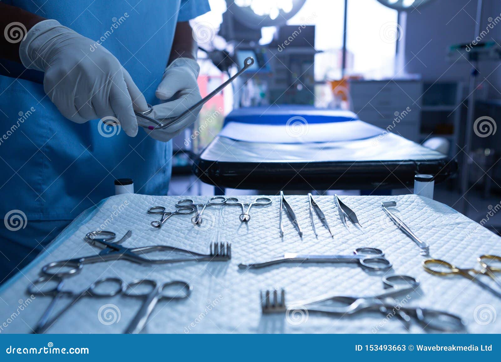 surgeon holding surgical instrument in operating room of hospital