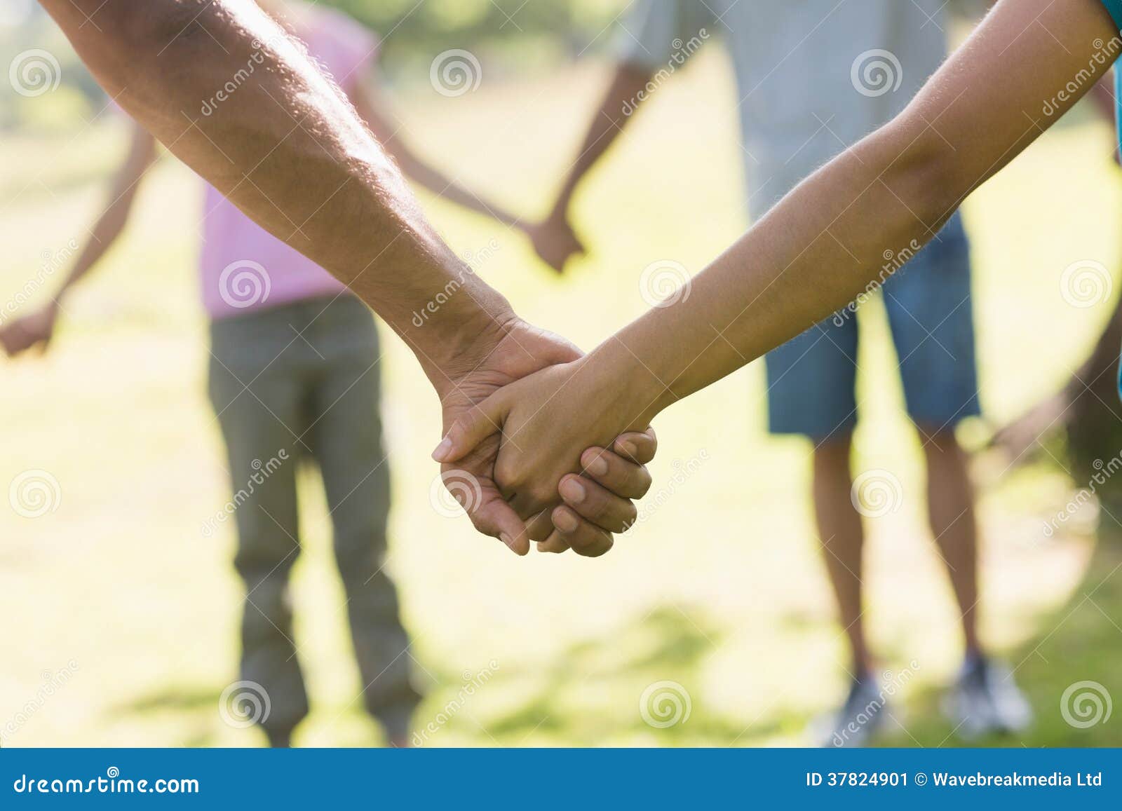 Mid Section of Friends Holding Hands in Park Stock Image Image of