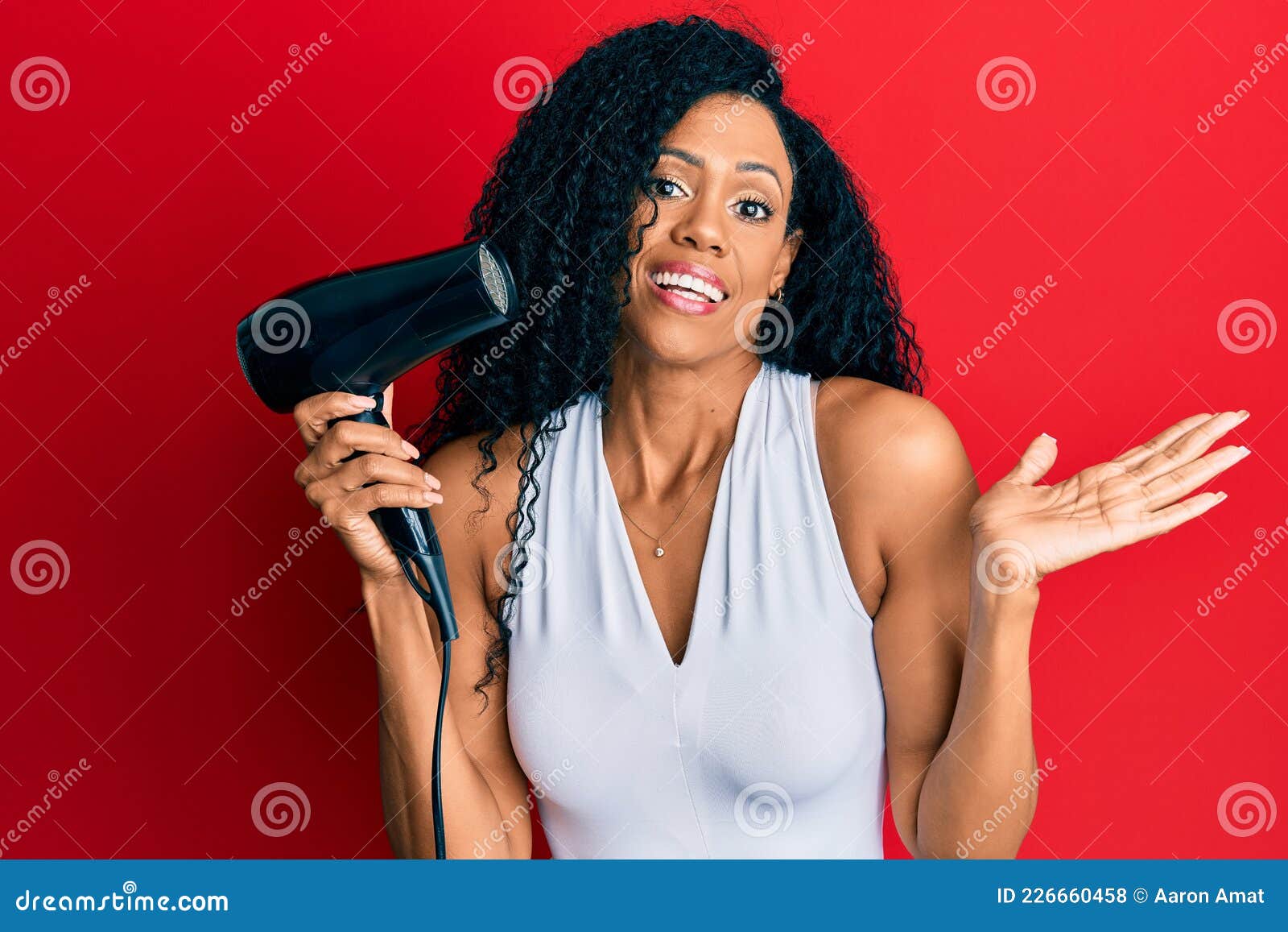 Middle Age African American Woman Holding Hair Dryer Celebrating  Achievement with Happy Smile and Winner Expression with Raised Stock Photo  - Image of african, blow: 226660458
