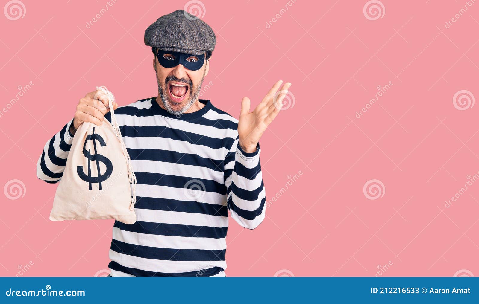 Middle Age Handsome Man Wearing Burglar Mask Holding Money Bag Celebrating Victory With Happy