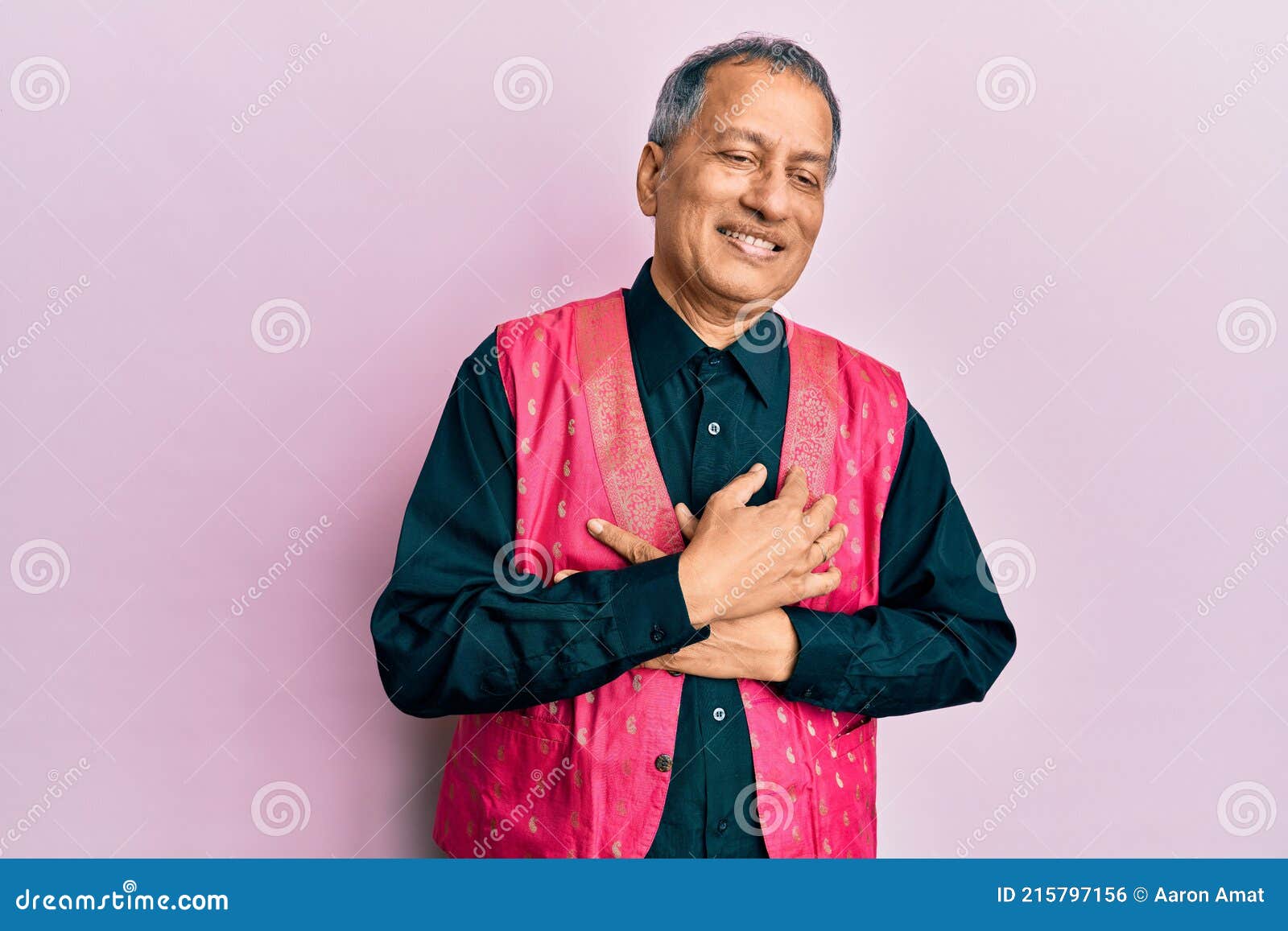 Middle age indian man wearing traditional indian clothes smiling