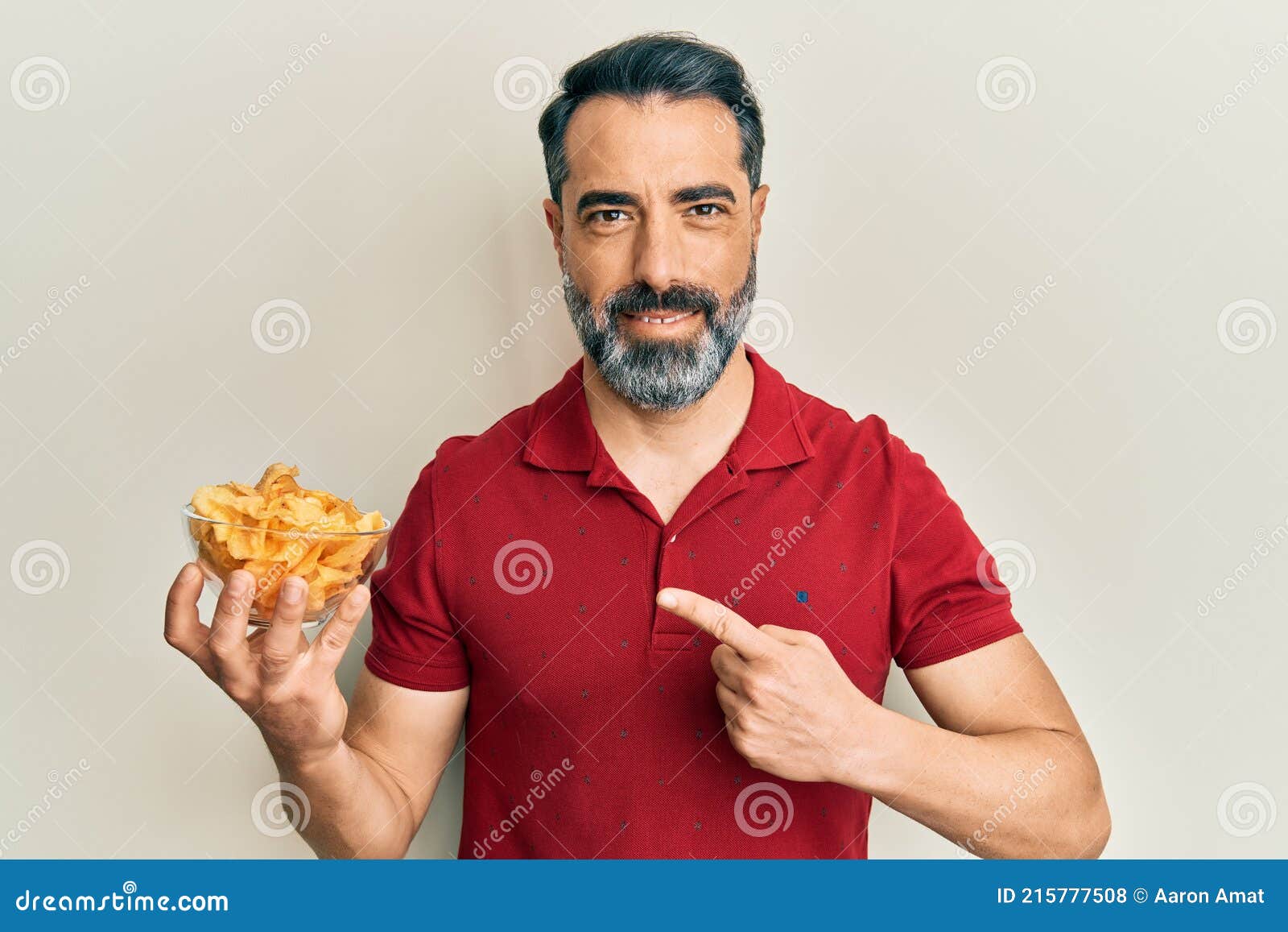 Middle Age Man with Beard and Grey Hair Holding Potato Chip Smiling Happy  Pointing with Hand and Finger Stock Photo - Image of middle, attractive:  215777508