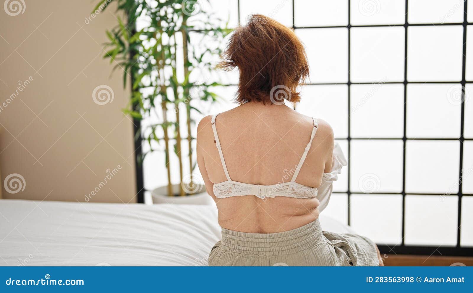Naked Woman Taking Off Or Putting On Bra Behind The Glass. Stock Photo,  Picture and Royalty Free Image. Image 117774632.