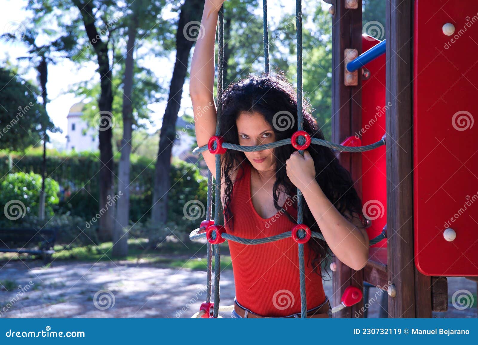 Middle-aged Adult Hispanic Woman with Black Curly Hair, Holding on To the  Ropes of a Child`s Game, with Mischievous Look. Concept Stock Image - Image  of hairstyle, hold: 230732119