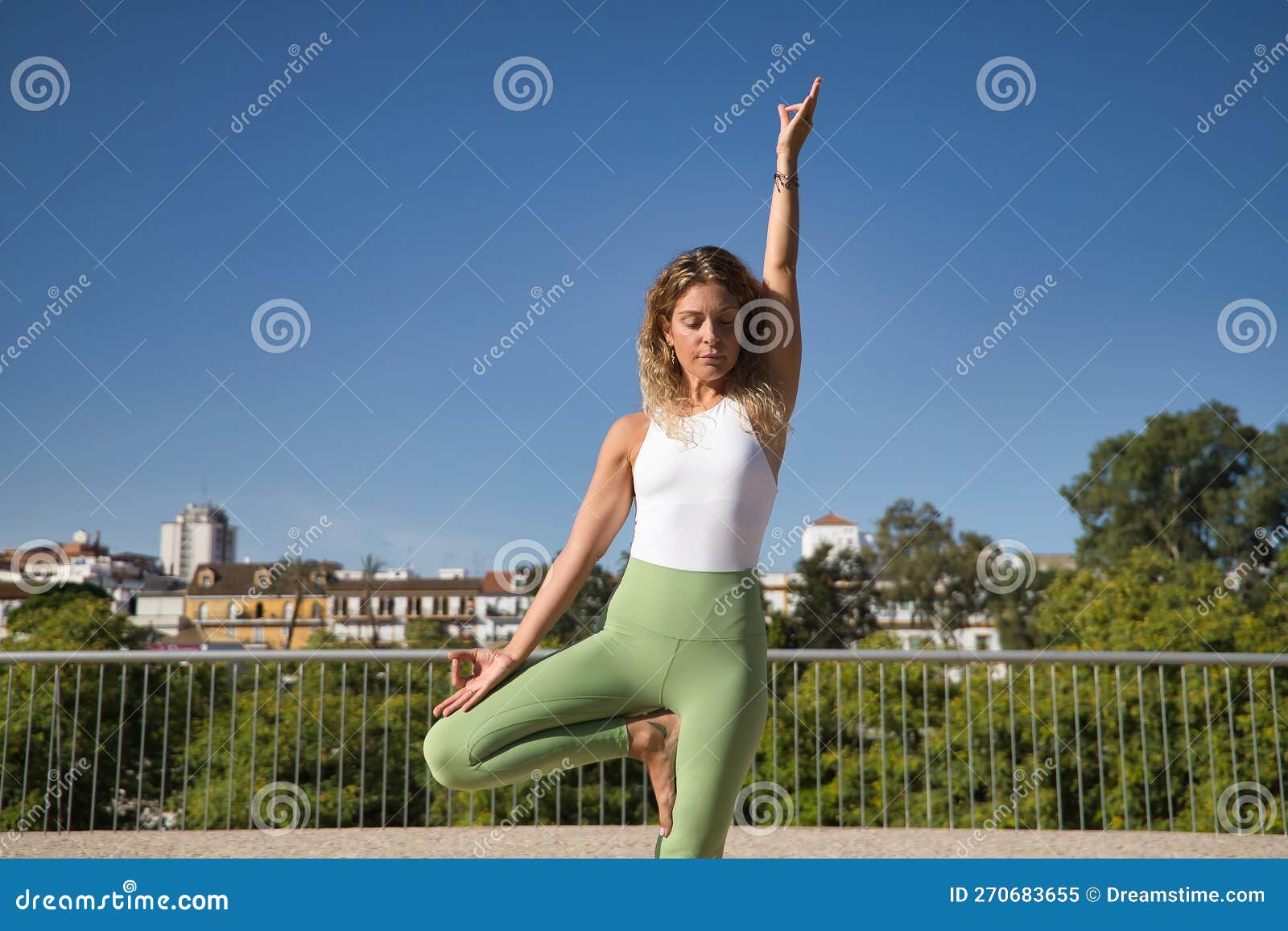 Middle-aged Blonde Woman, Wearing Green Leggings and White Top