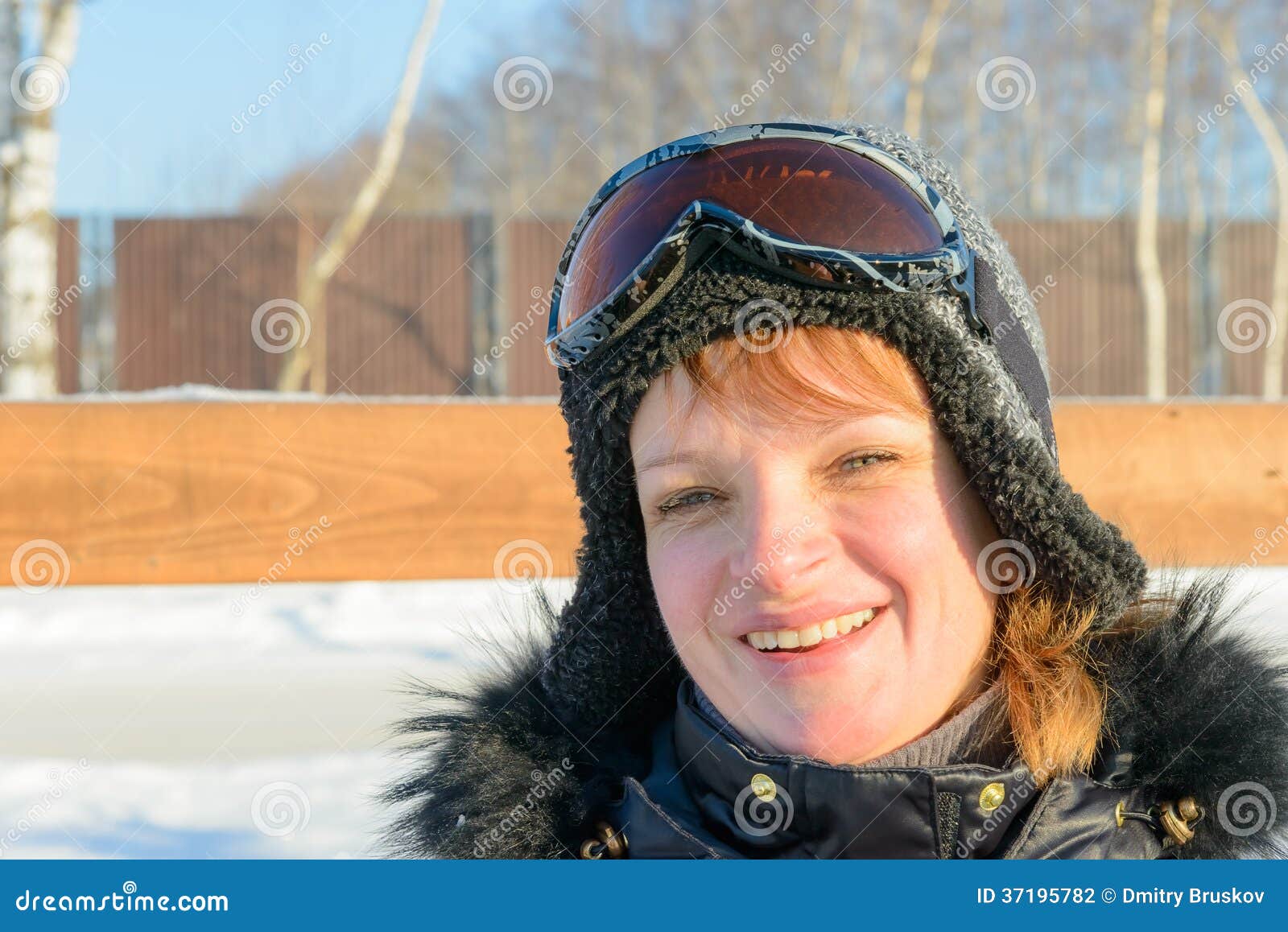 Middleaged on a Hillside in a Cap and Ski Goggles Stock Photo