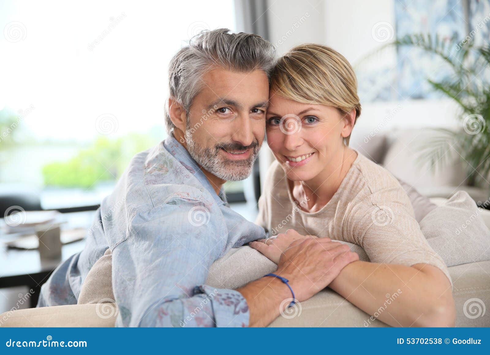 middle-aged couple embracing at home