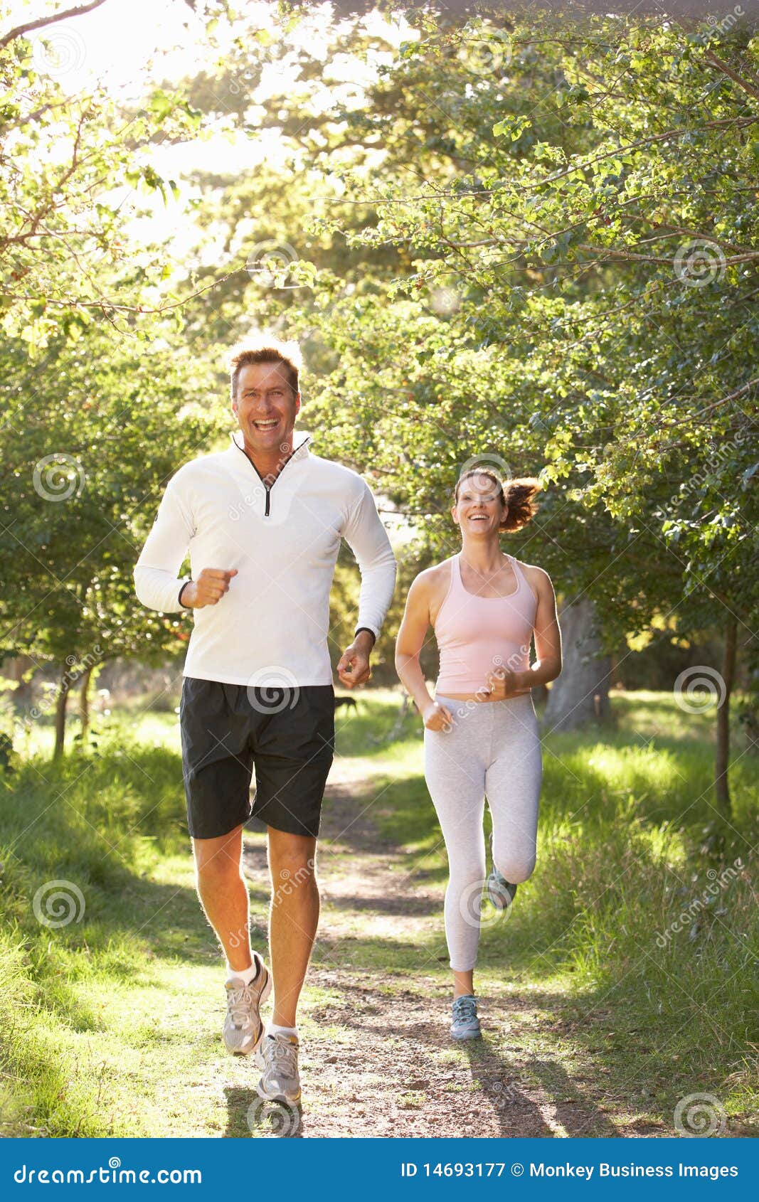 middle aged couple jogging in park